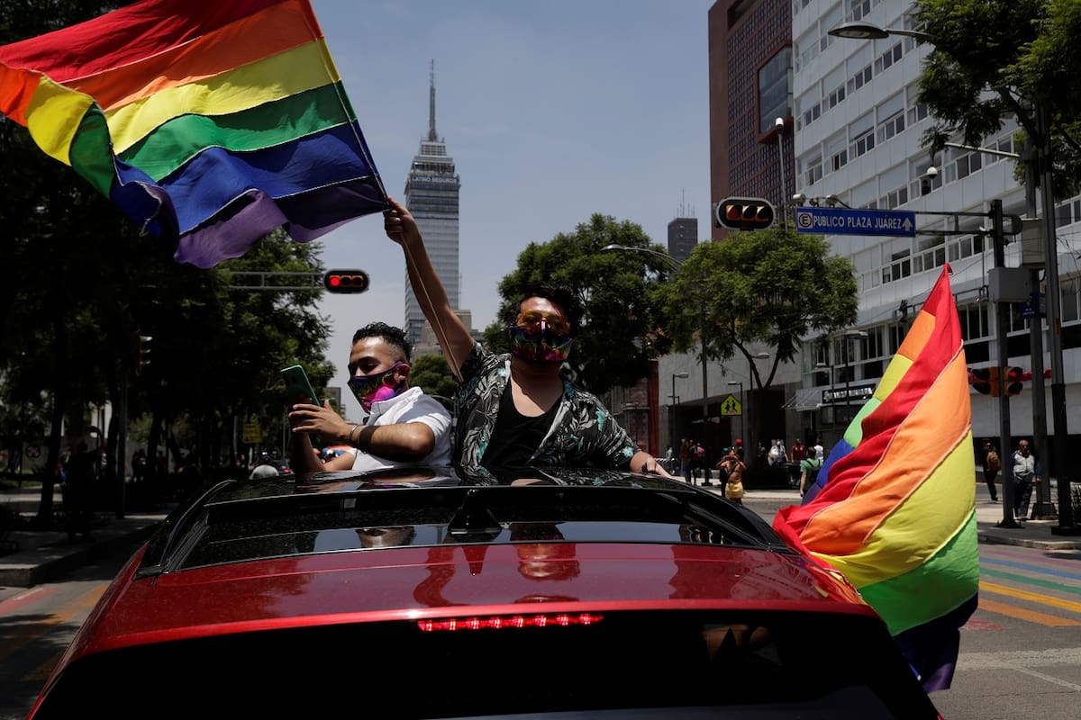 A participant flutters a rainbow flag near the Bellas Artes Palace to celebrate gay pride, although the Mexican LGBT community called for an online celebration as a protective measure amid the coronavirus disease (COVID-19) outbreak, in Mexico City, Mexico June 27, 2020 REUTERS/Henry Romero
